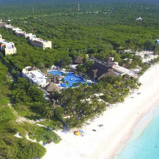 Aerial view of Catalonia Royal Tulum resort buildings nestled in tropical jungle by the beach, Tulum