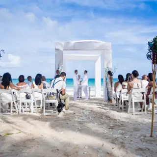 Beachfront wedding ceremony with a white gazebo at Catalonia Royal Tulum, Tulum