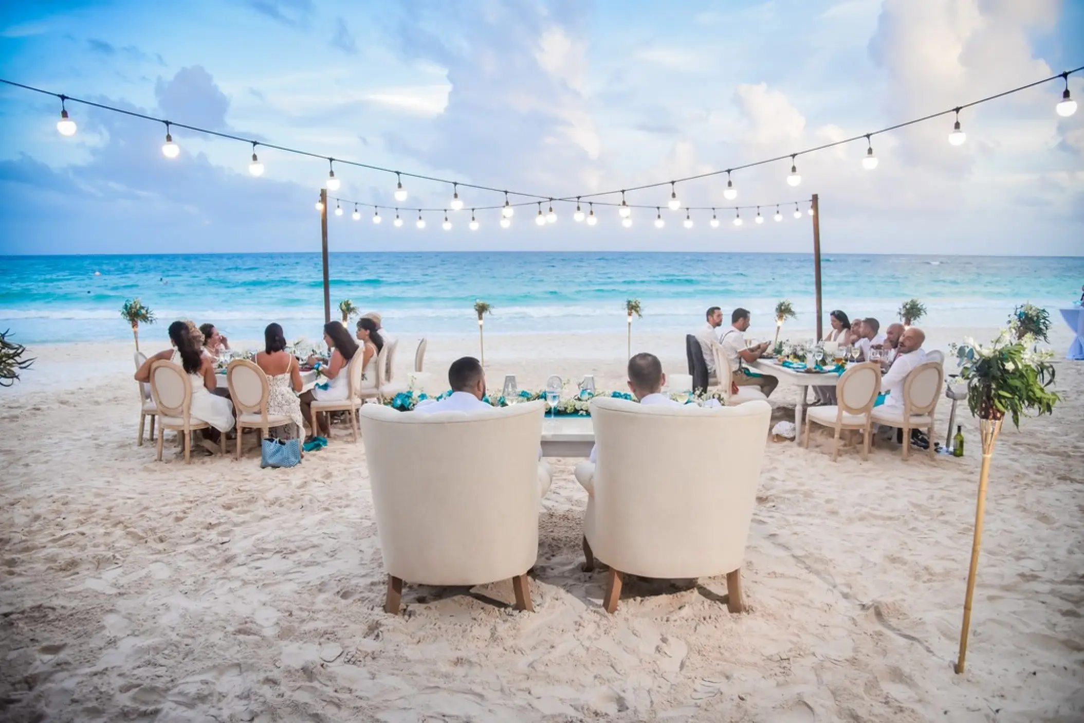 Beachfront wedding reception dinner with string lights at Catalonia Royal Tulum, Tulum