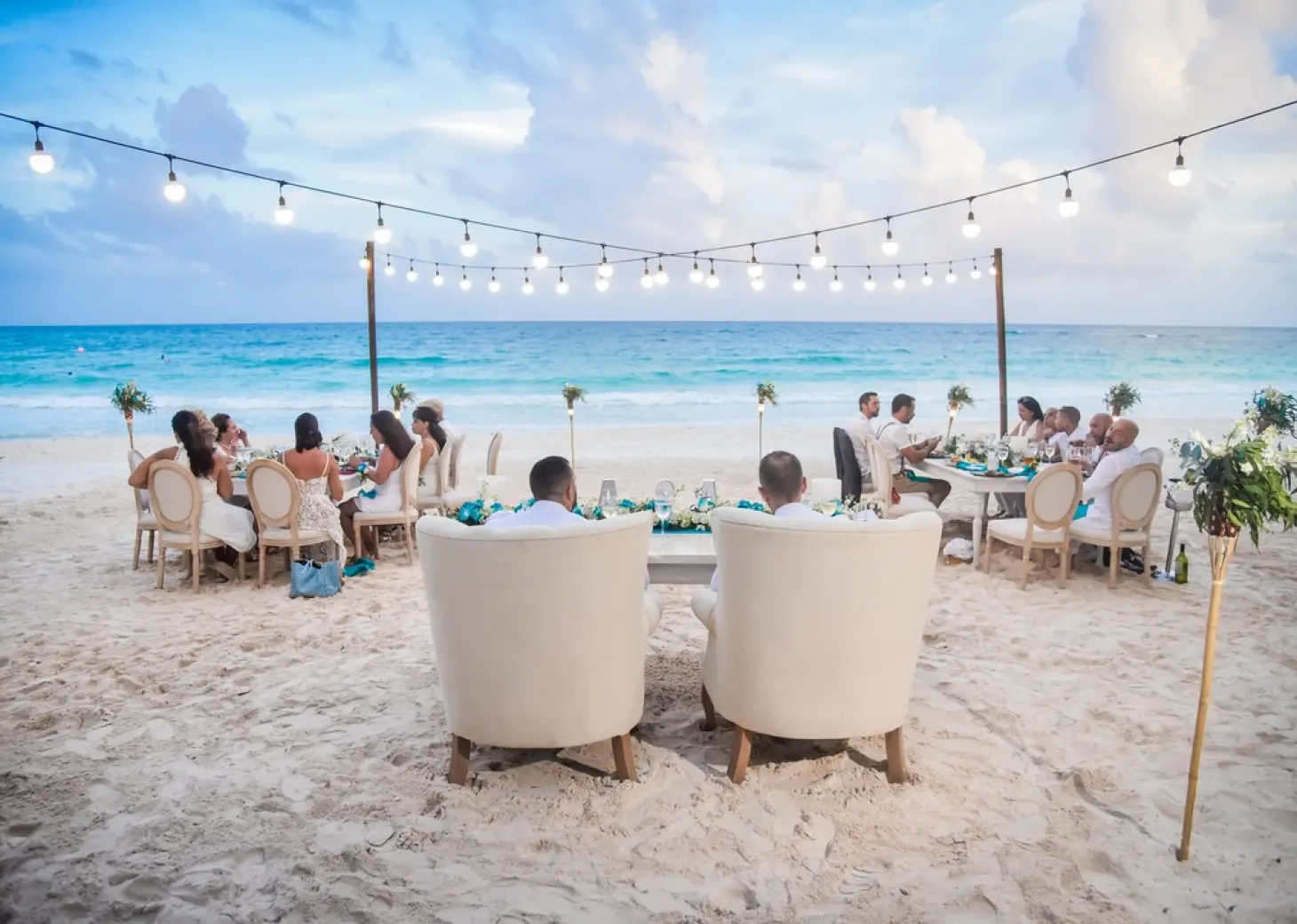 Beachfront wedding reception dinner with string lights at Catalonia Royal Tulum, Tulum