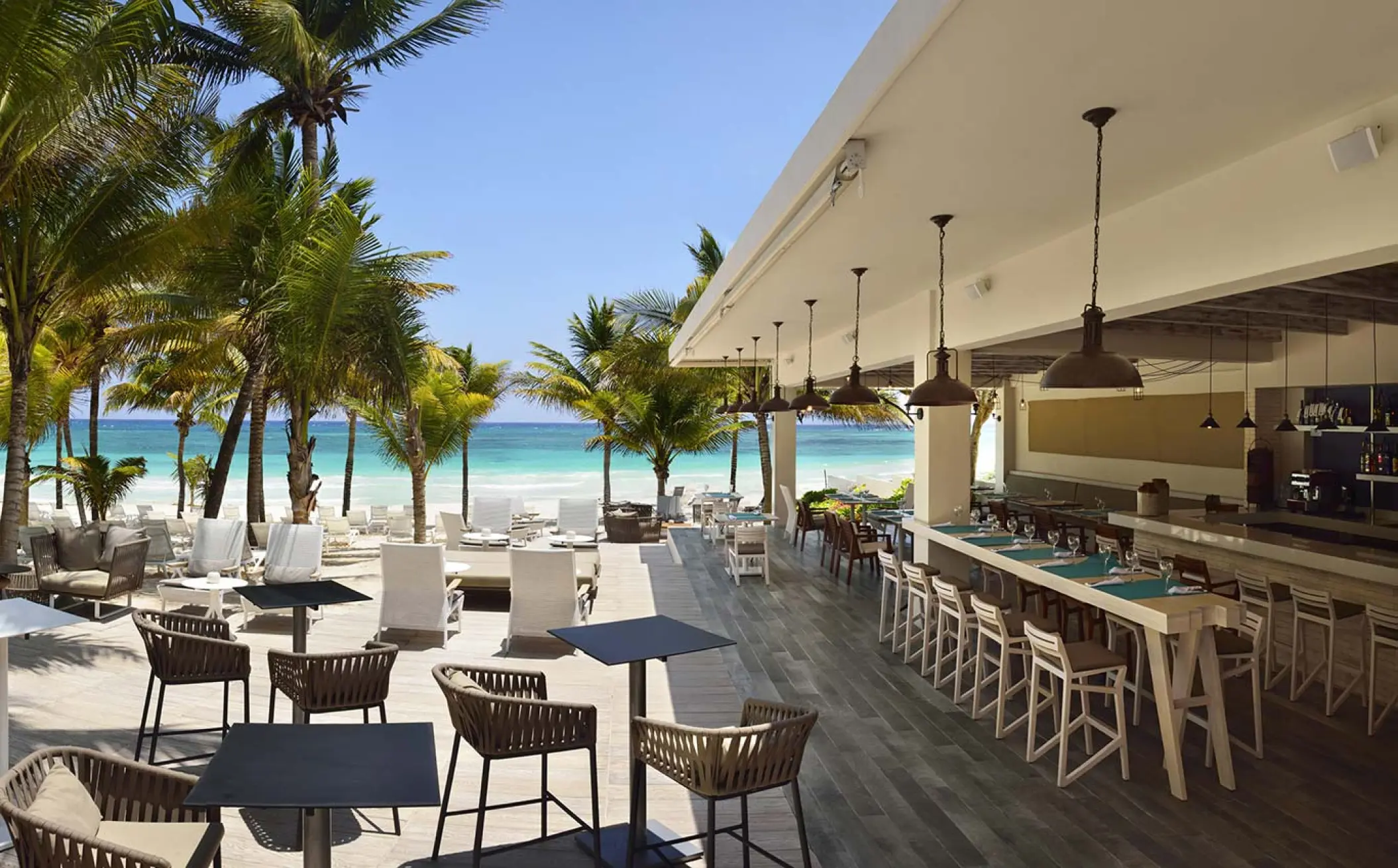 Bloved restaurant outdoor seating and bar area overlooking the beach at Catalonia Royal Tulum, Tulum