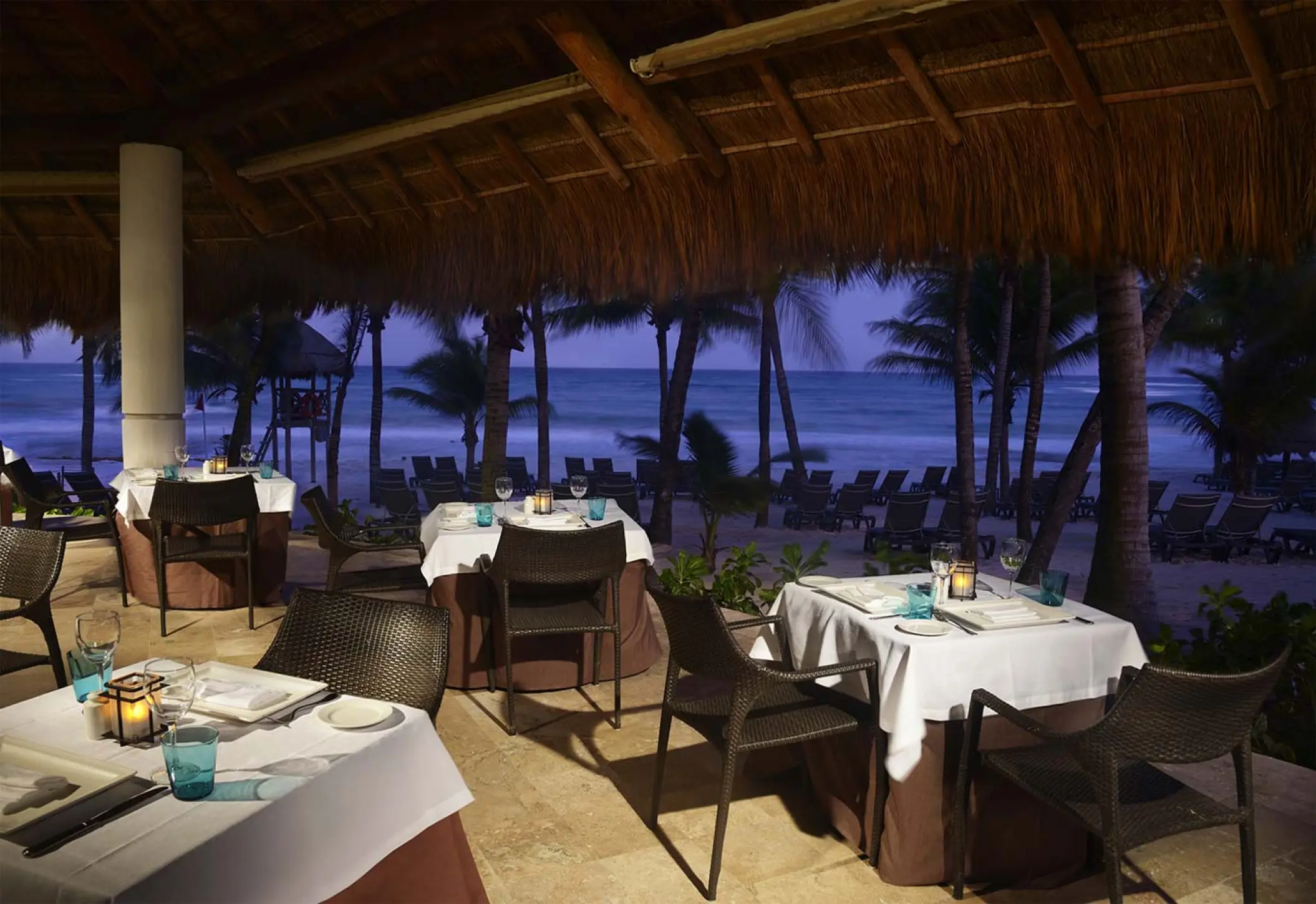 La Palapa beachfront restaurant at Catalonia Royal Tulum overlooking the ocean at dusk