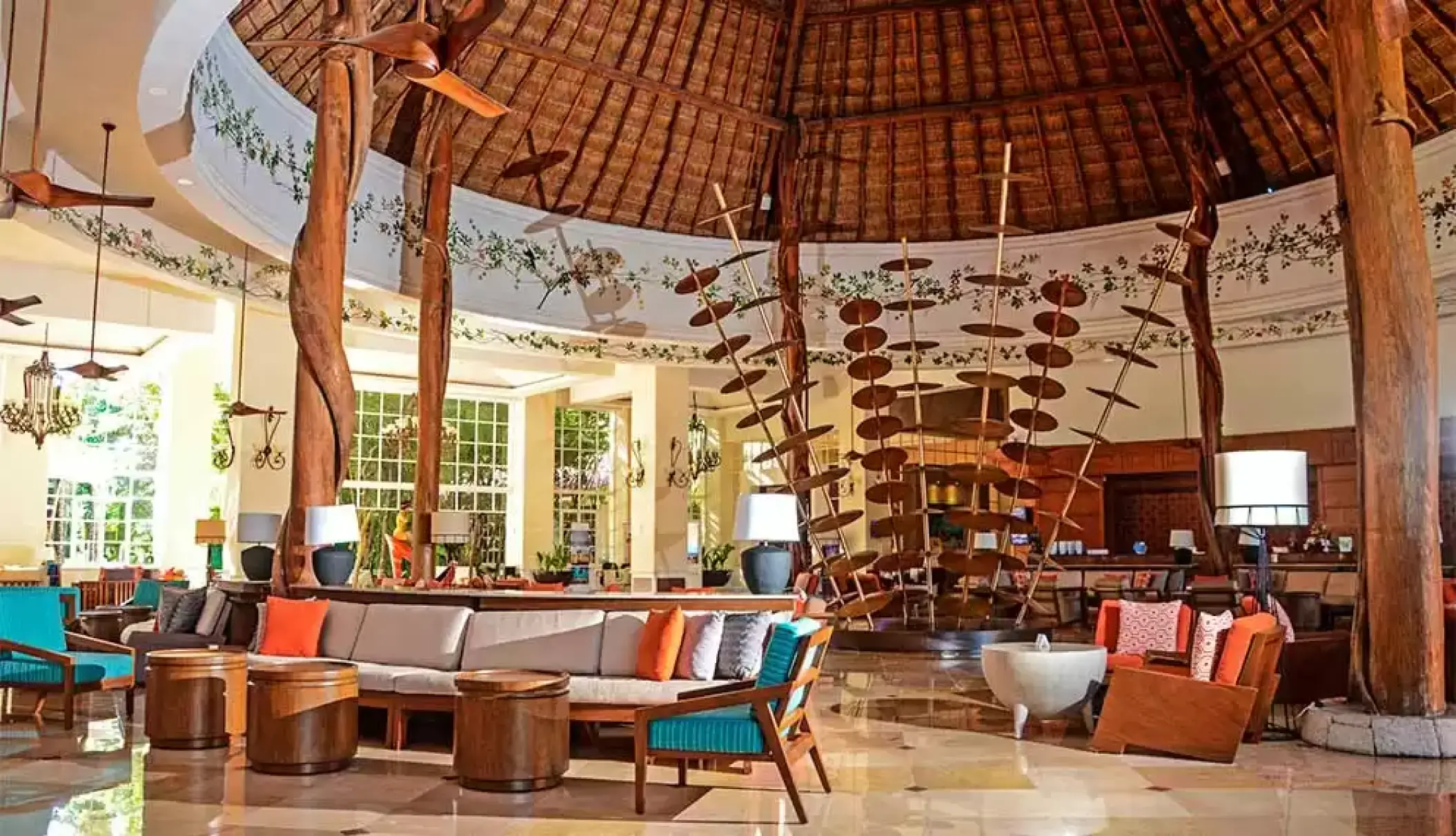 Catalonia Royal Tulum lobby with thatched palapa roof and tropical wood pillars, Tulum
