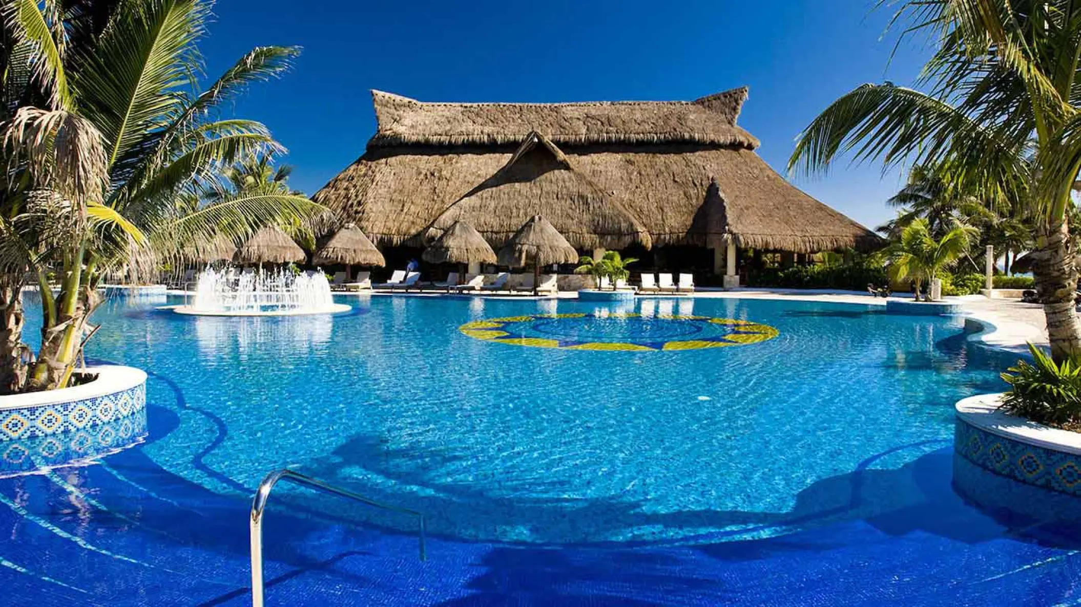 Catalonia Royal Tulum swimming pool with fountain and large palapa, Tulum