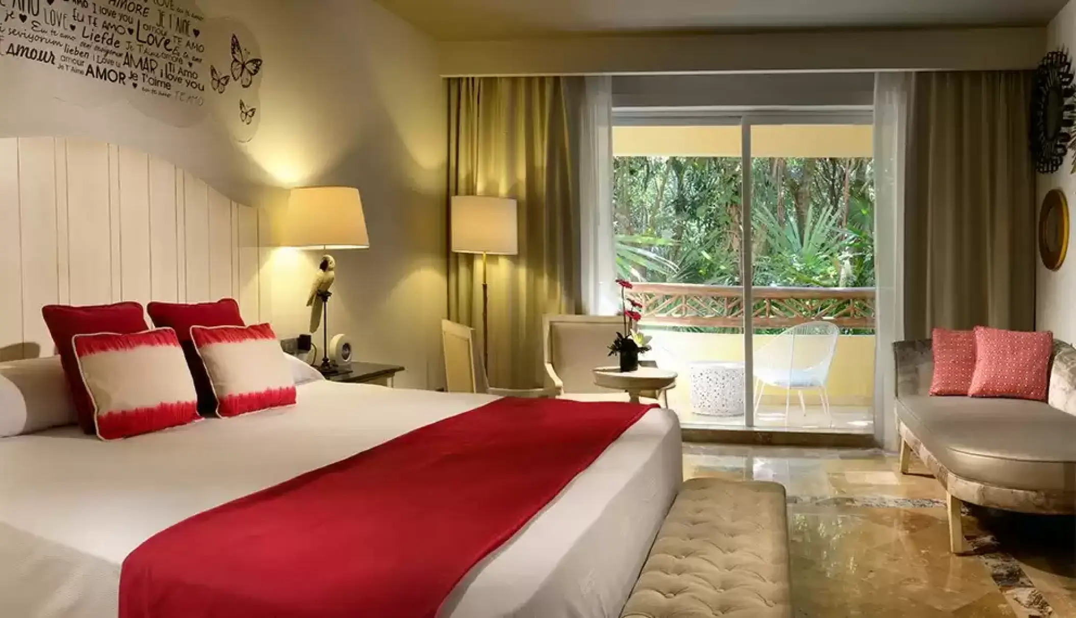 Privileged deluxe room with red accents and jungle view balcony at Catalonia Royal Tulum