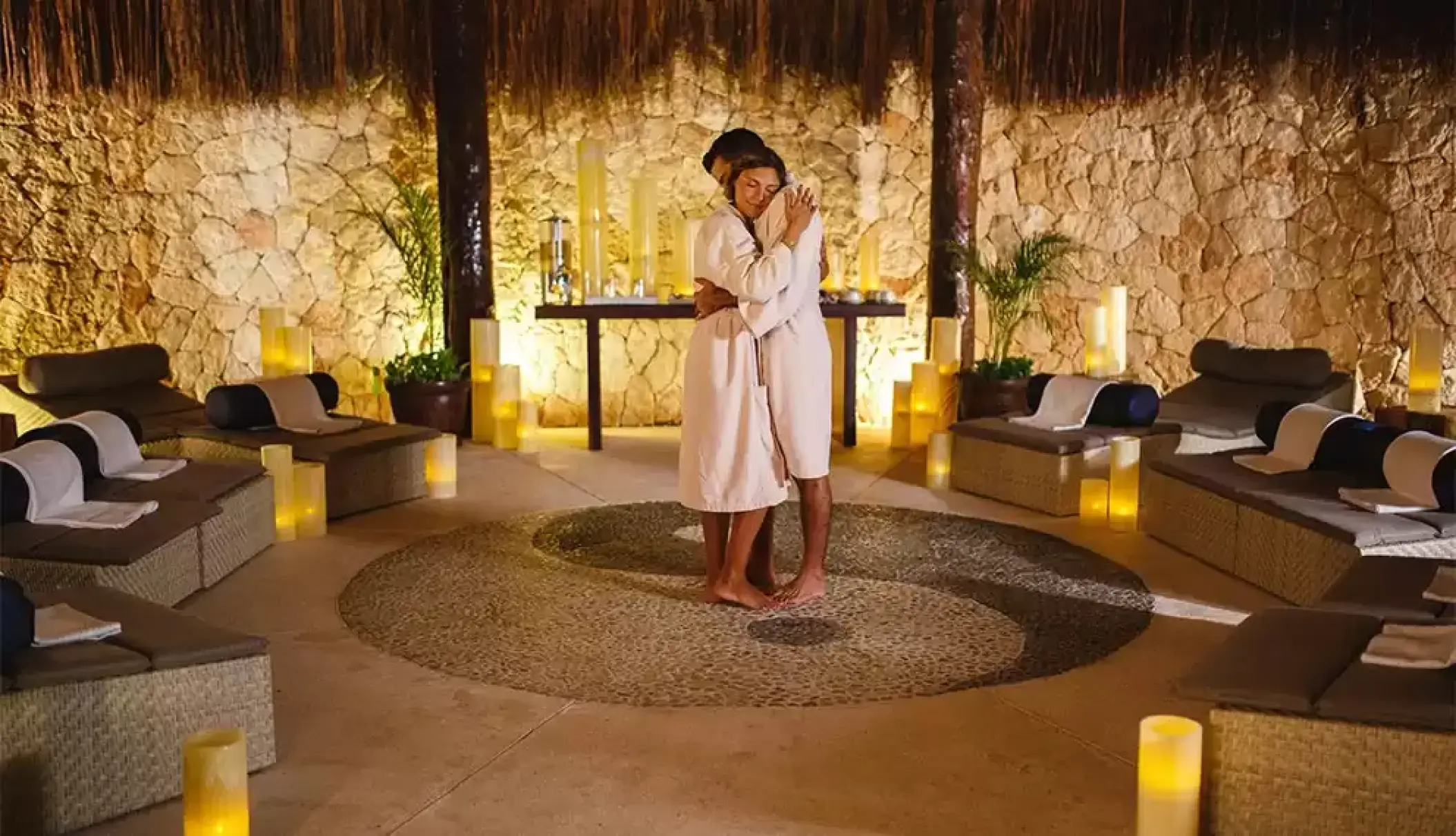 Couple in white robes embracing in the spa at Catalonia Royal Tulum, Tulum