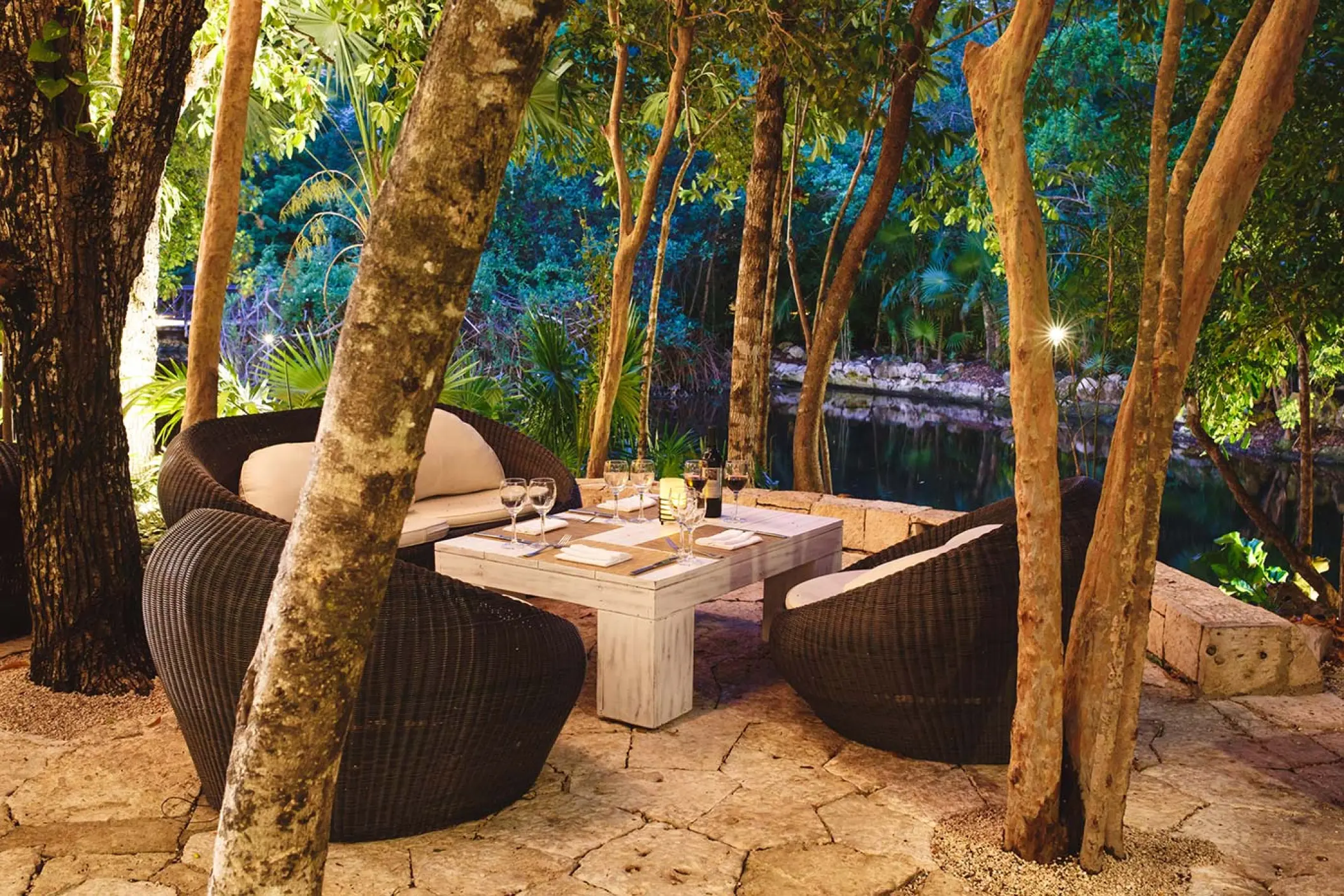 Outdoor terrace tapas lounge surrounded by trees at Catalonia Royal Tulum