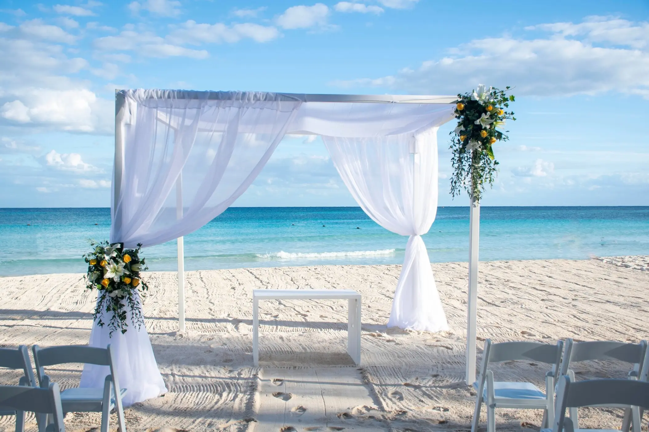 Beachfront wedding ceremony with a white fabric gazebo at Catalonia Royal Tulum, Tulum