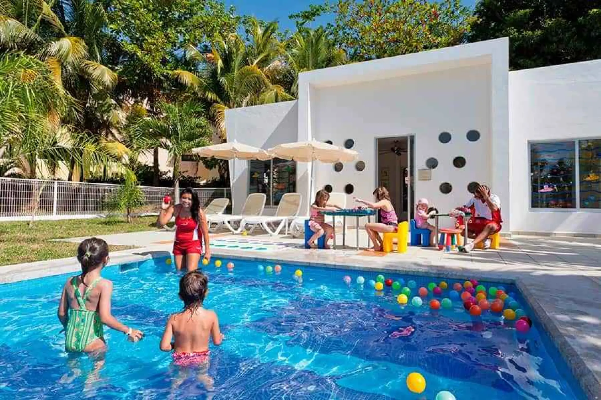 Children playing in a pool with colorful balls at Riu Palace Mexico, Playa Del Carmen
