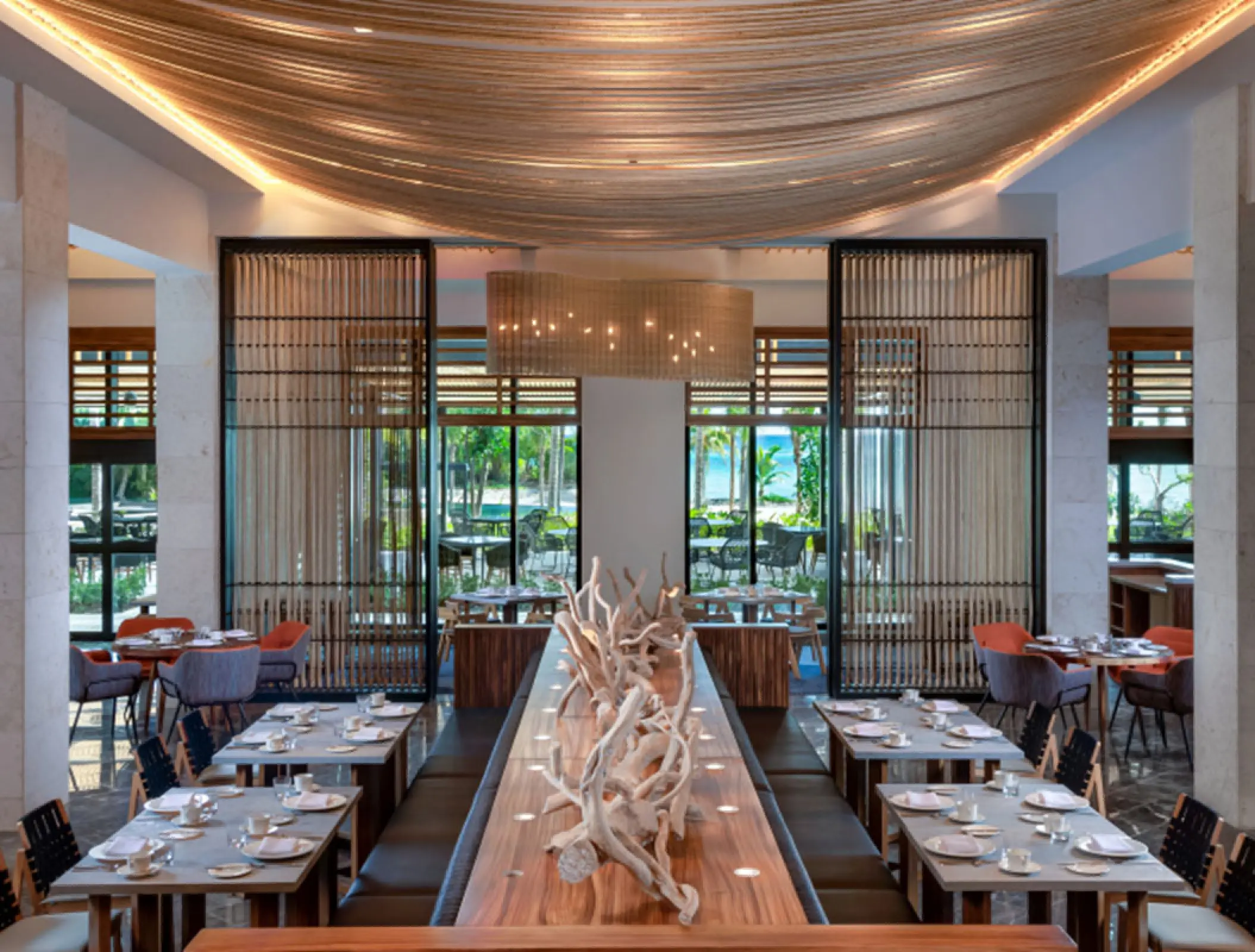 Modern restaurant dining room with wood accents at Conrad Tulum, Tulum