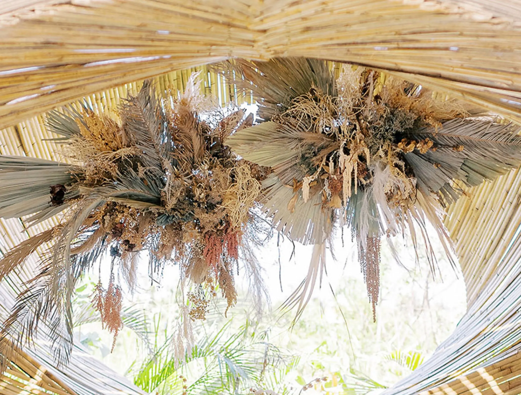 Dried floral arrangements hanging from a bamboo structure at Conrad Tulum, Tulum