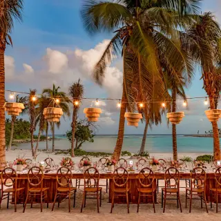 Long reception table with string lights on the beach at Conrad Tulum, Tulum