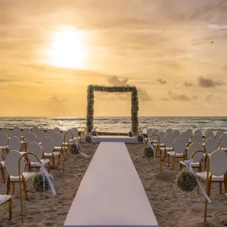 Beachfront wedding ceremony setup at Conrad Tulum at sunset, Tulum