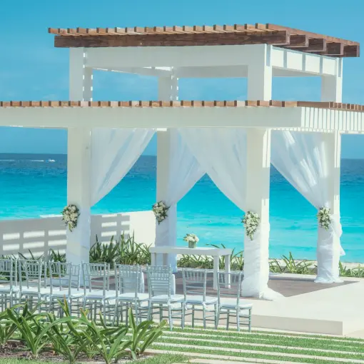 Beachfront wedding ceremony gazebo with white draping at Coral Level at Iberostar Selection Cancun