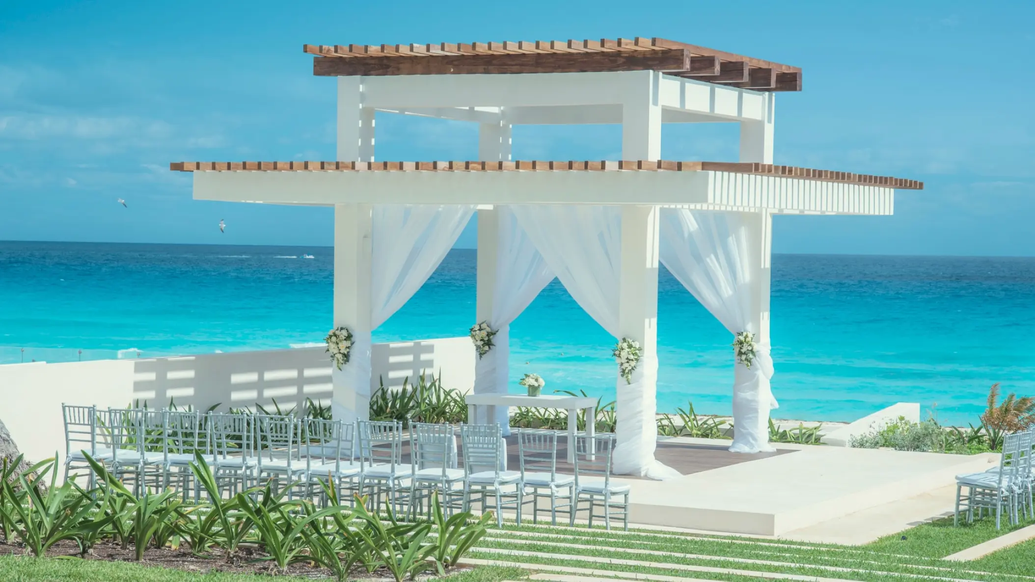 Beachfront wedding ceremony gazebo with white draping at Coral Level at Iberostar Selection Cancun