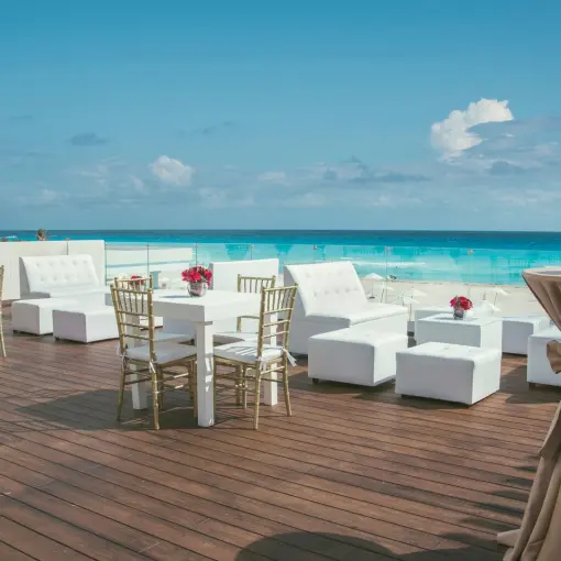 Terrace wedding reception with white lounge seating at Iberostar Selection Cancun