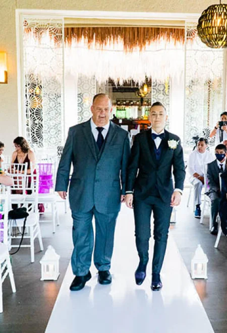 groom walking down the isle with his father