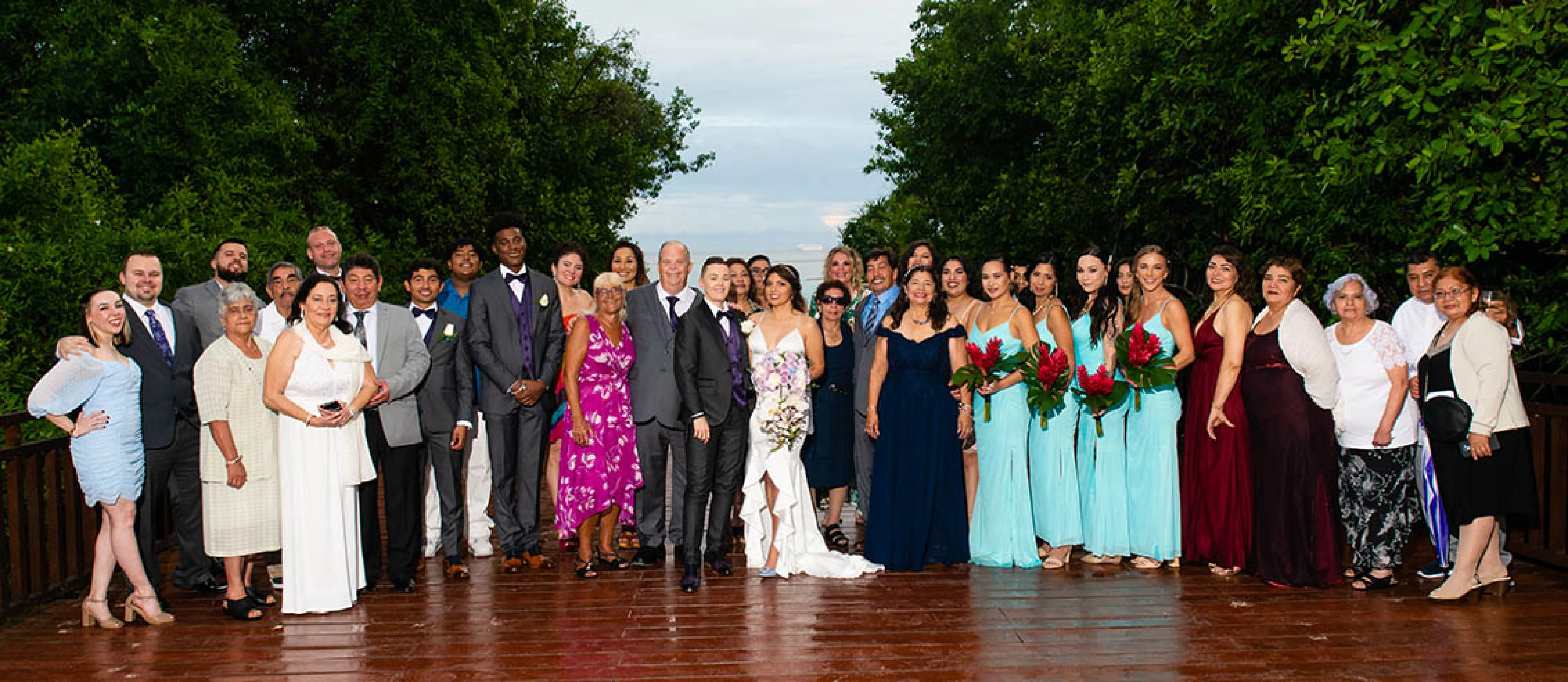 wedding group photo at a tropical deck