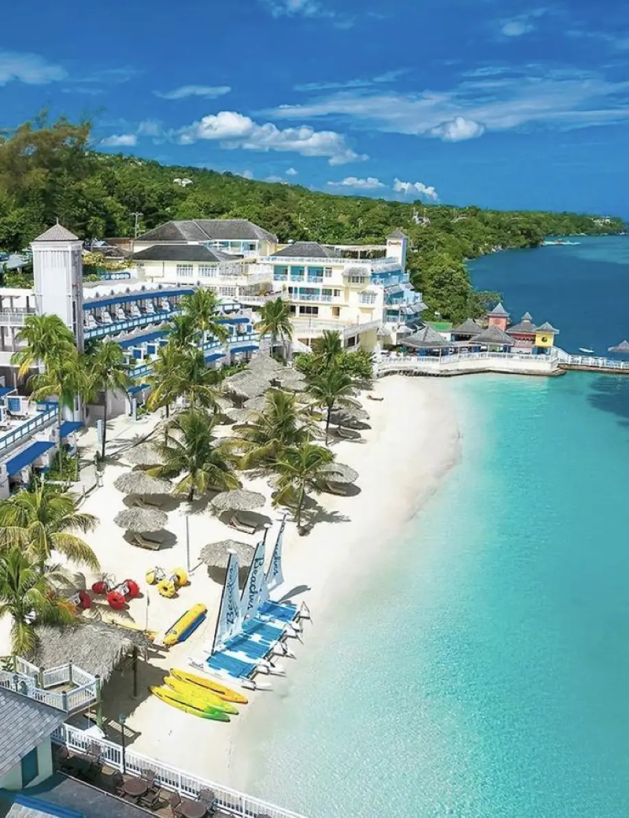 Aerial view of a white sand beach and turquoise water at a resort in Ocho Rios
