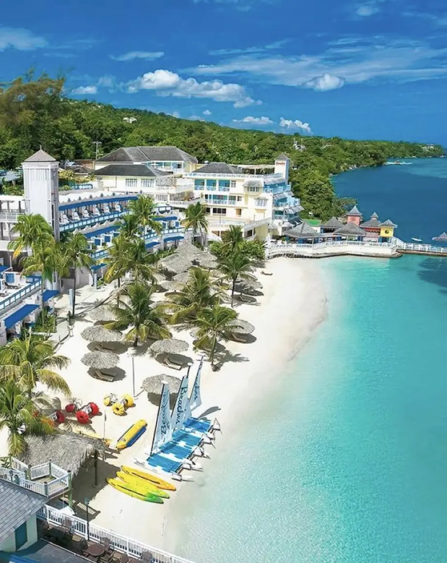 Aerial view of a white sand beach and turquoise water at a resort in Ocho Rios