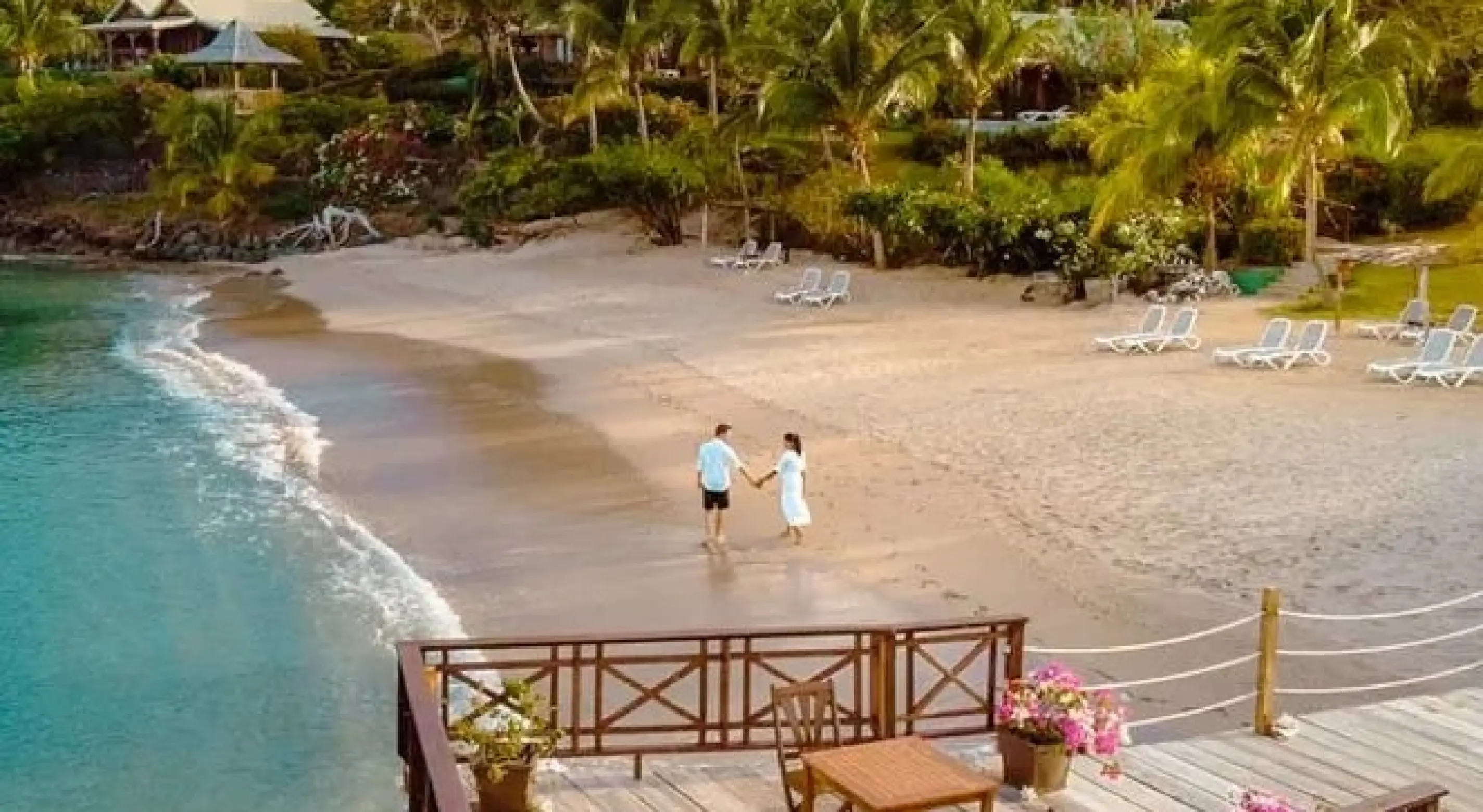 Couple walking along the beach at Calabash Cove, Saint Lucia