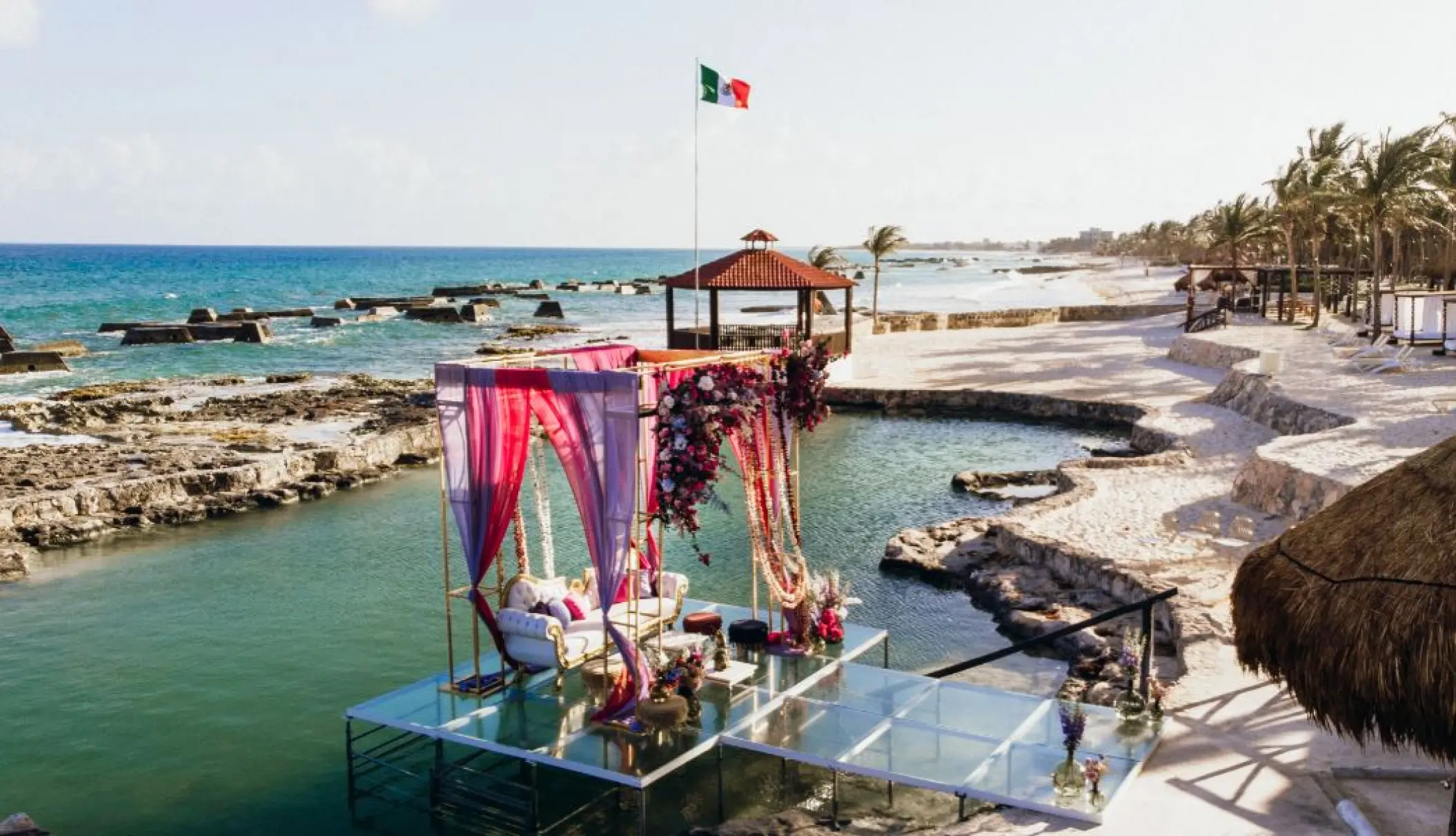 Glass floor wedding ceremony setup over the water at El Dorado Casitas Royale, Riviera Maya