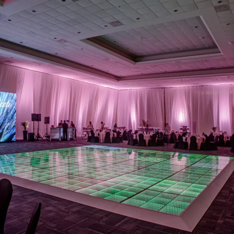 Indoor ballroom wedding reception with a green LED dance floor at El Dorado Casitas Royale, Riviera Maya