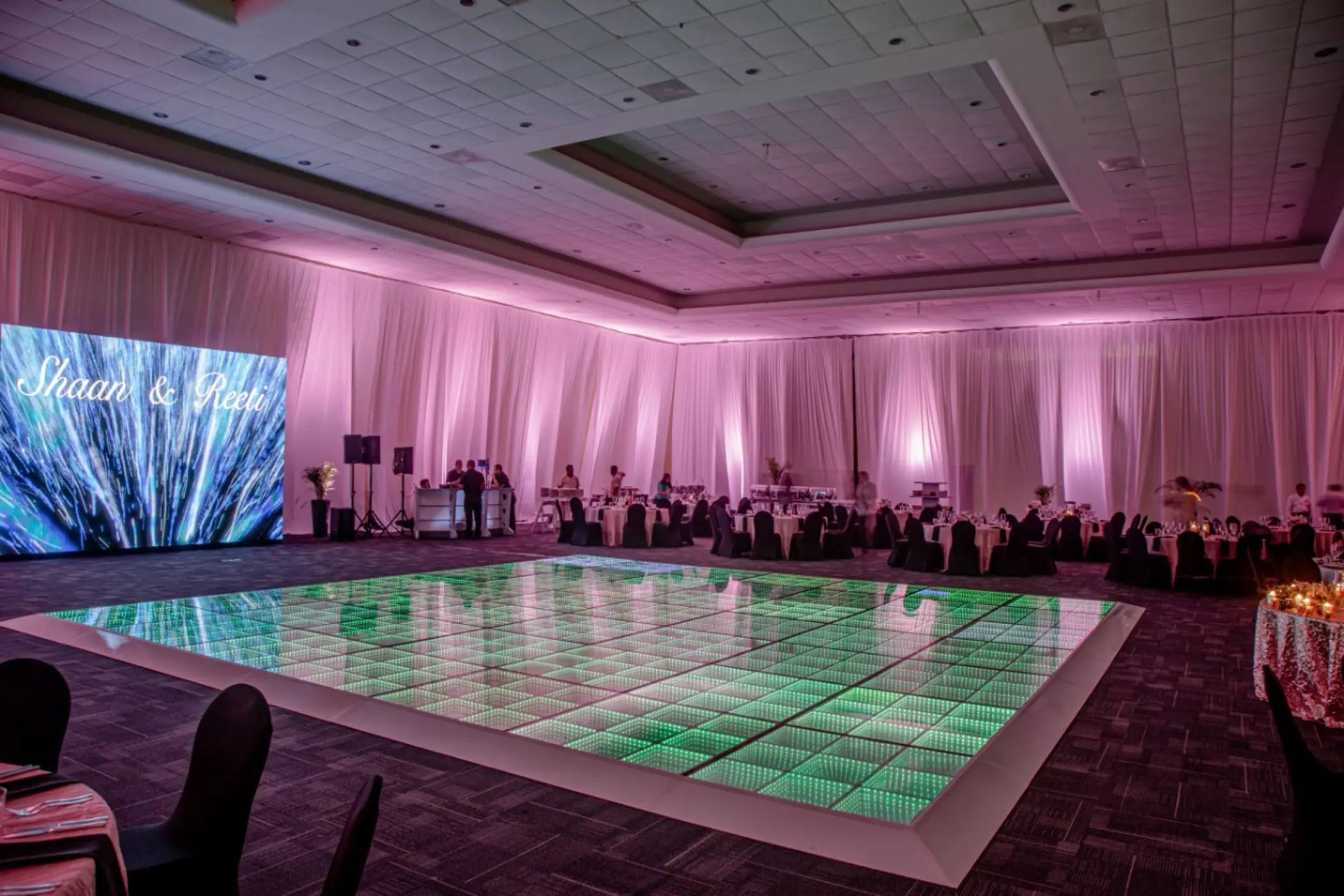 Indoor ballroom wedding reception with a green LED dance floor at El Dorado Casitas Royale, Riviera Maya