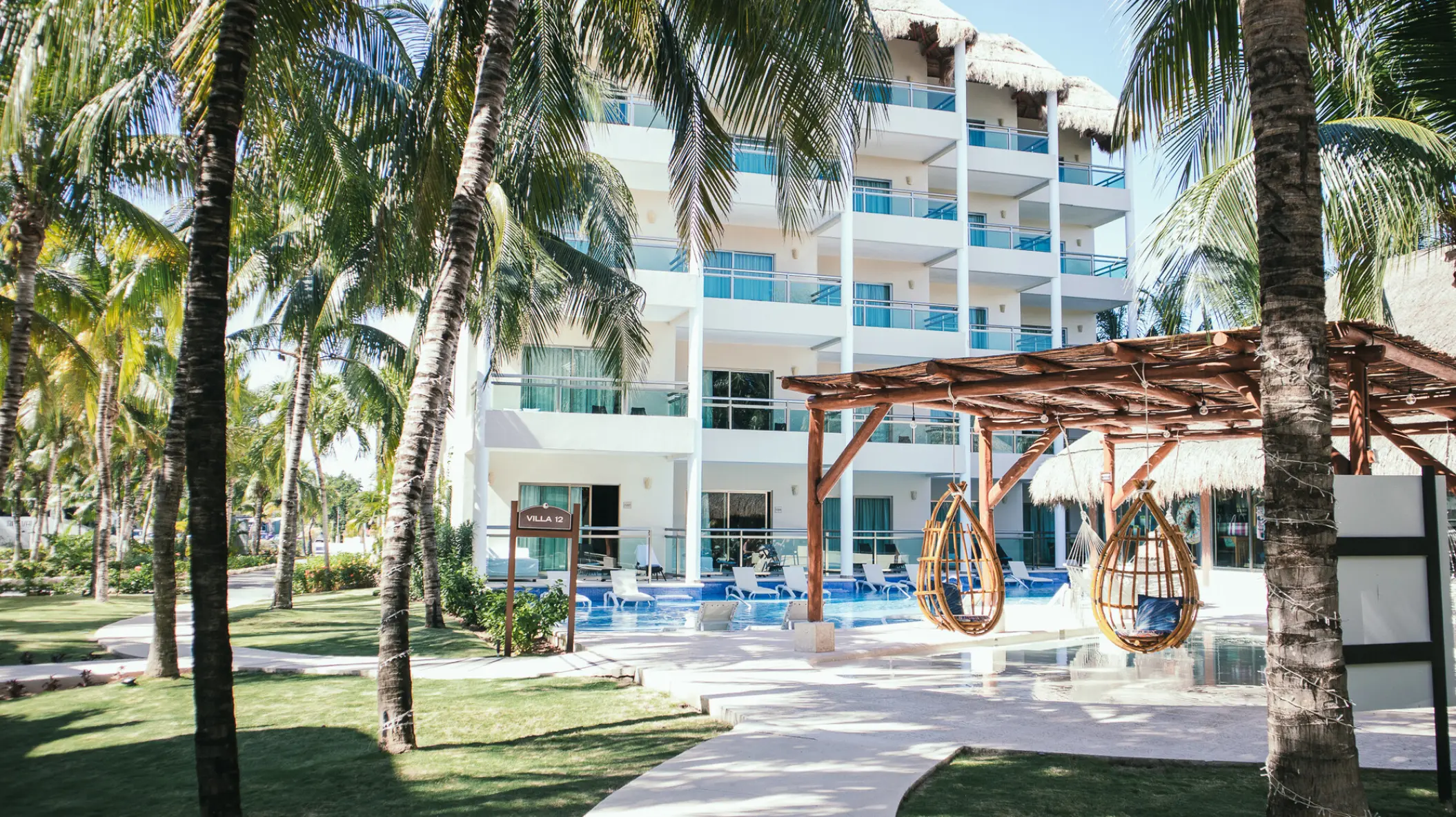 White suite buildings and pool area at El Dorado Maroma, Riviera Maya