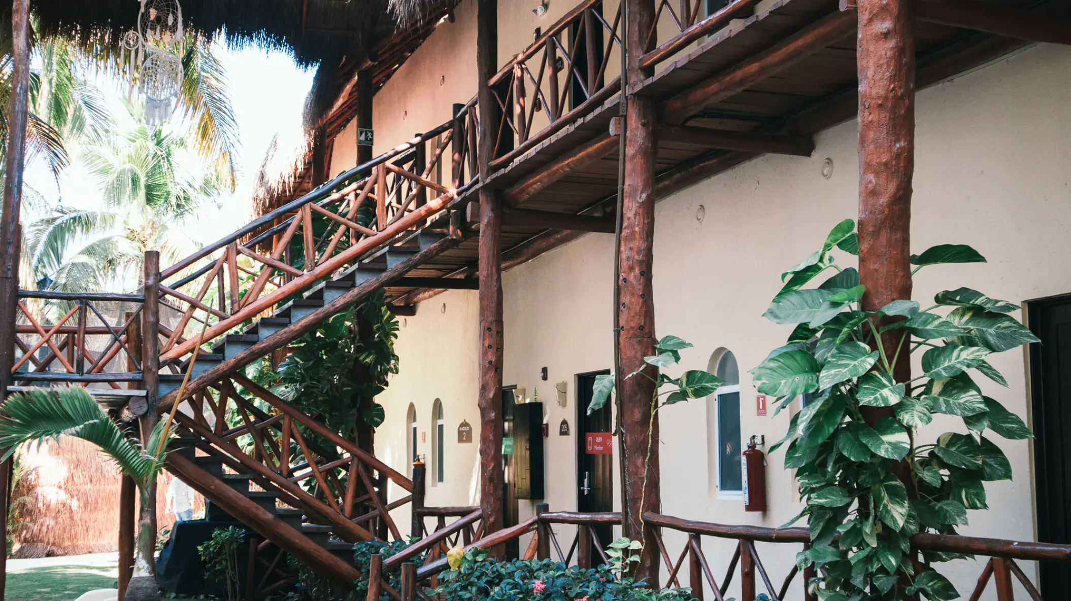Wooden stairs and balcony exterior of the guest suites at El Dorado Maroma, Riviera Maya
