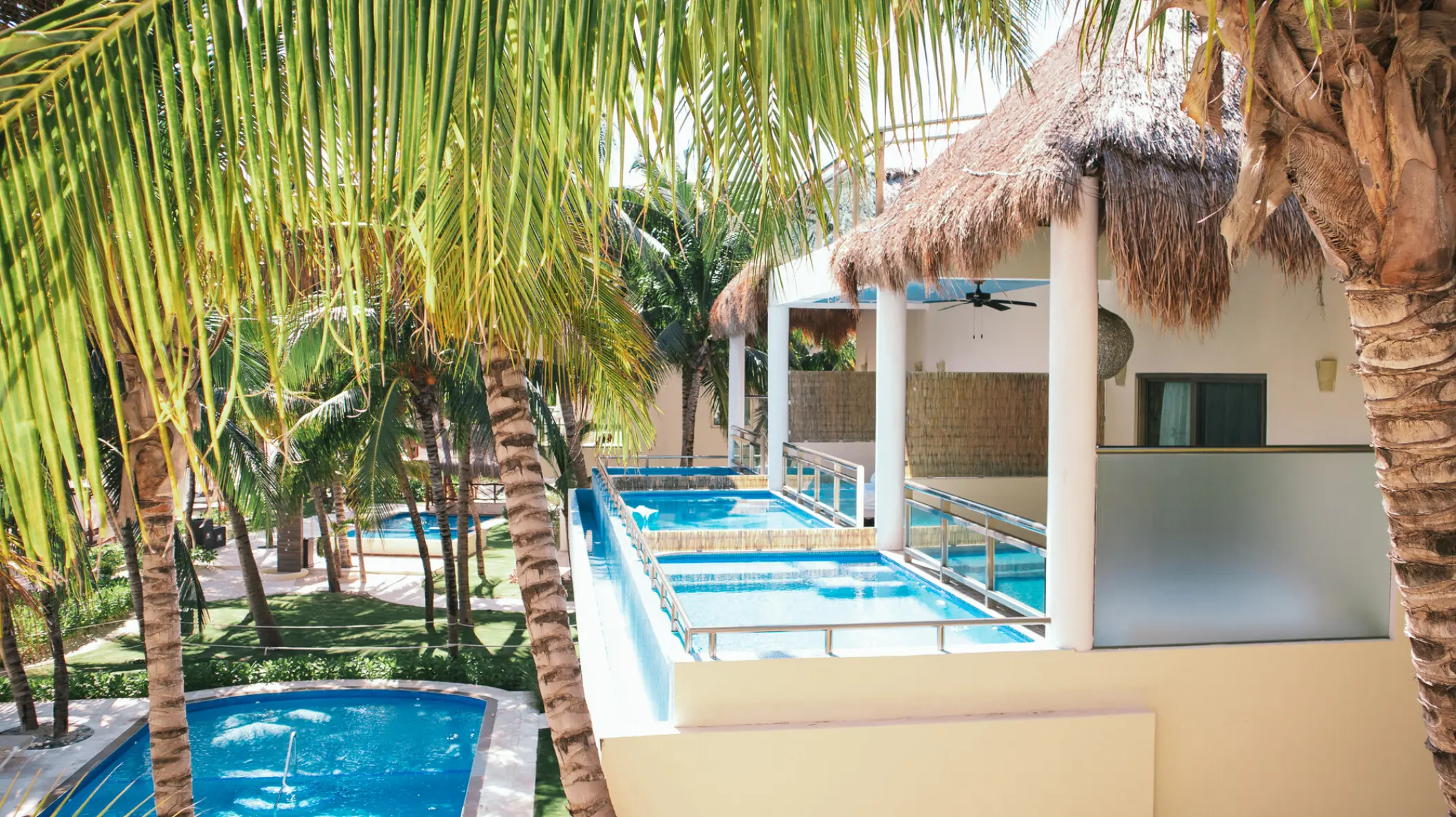 Swim-out suites with thatched roofs and private balconies at El Dorado Maroma, Riviera Maya