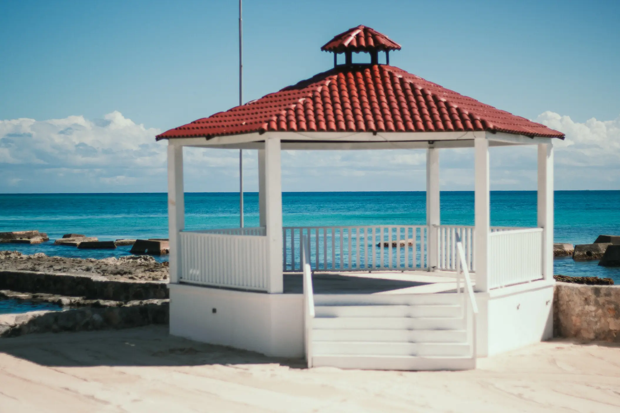 Oceanfront wedding gazebo with red tiled roof at El Dorado Royale, Riviera Maya