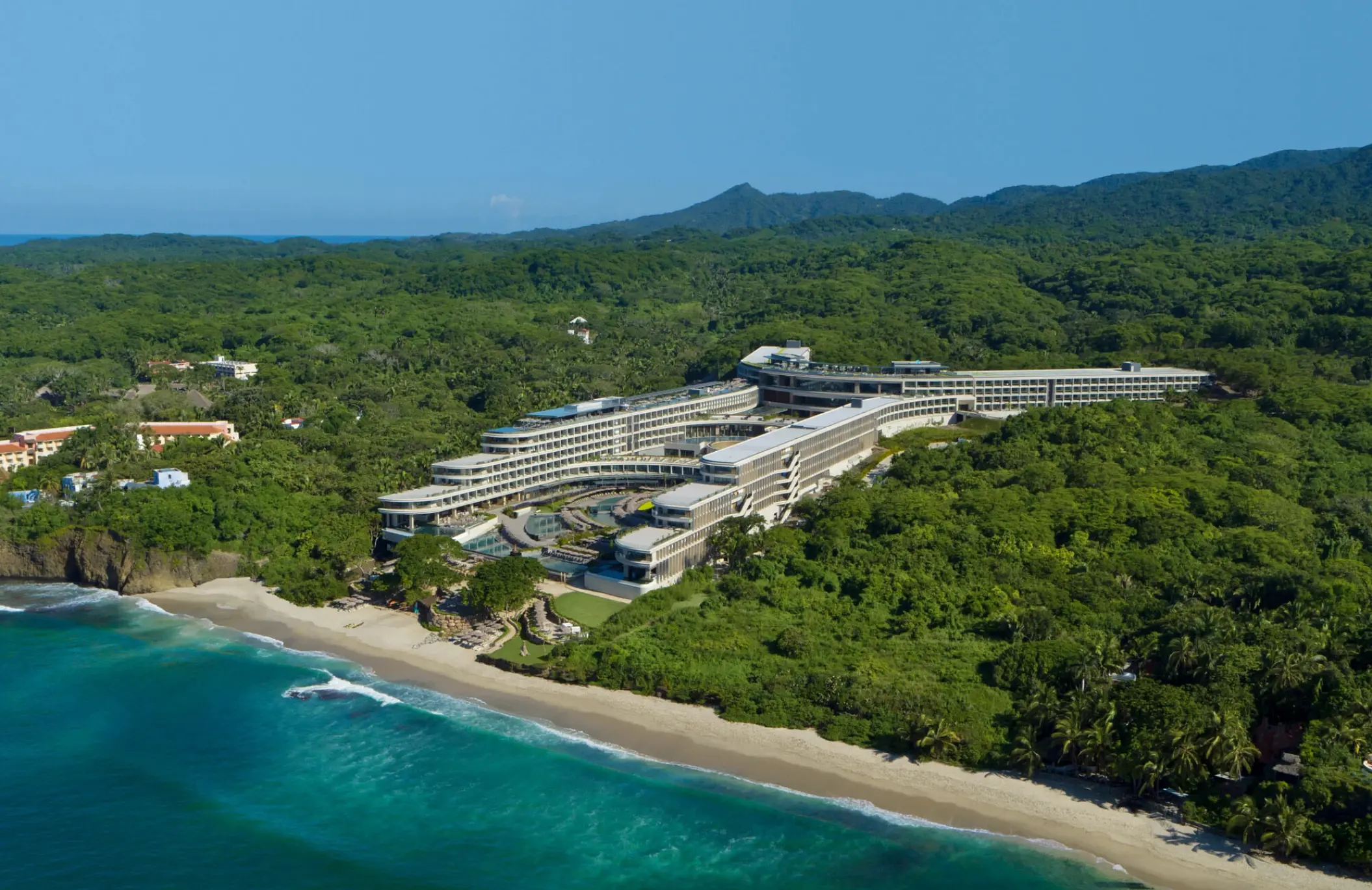 Aerial view of Secrets Bahia Mita surrounded by lush jungle and a white sand beach, Puerto Vallarta