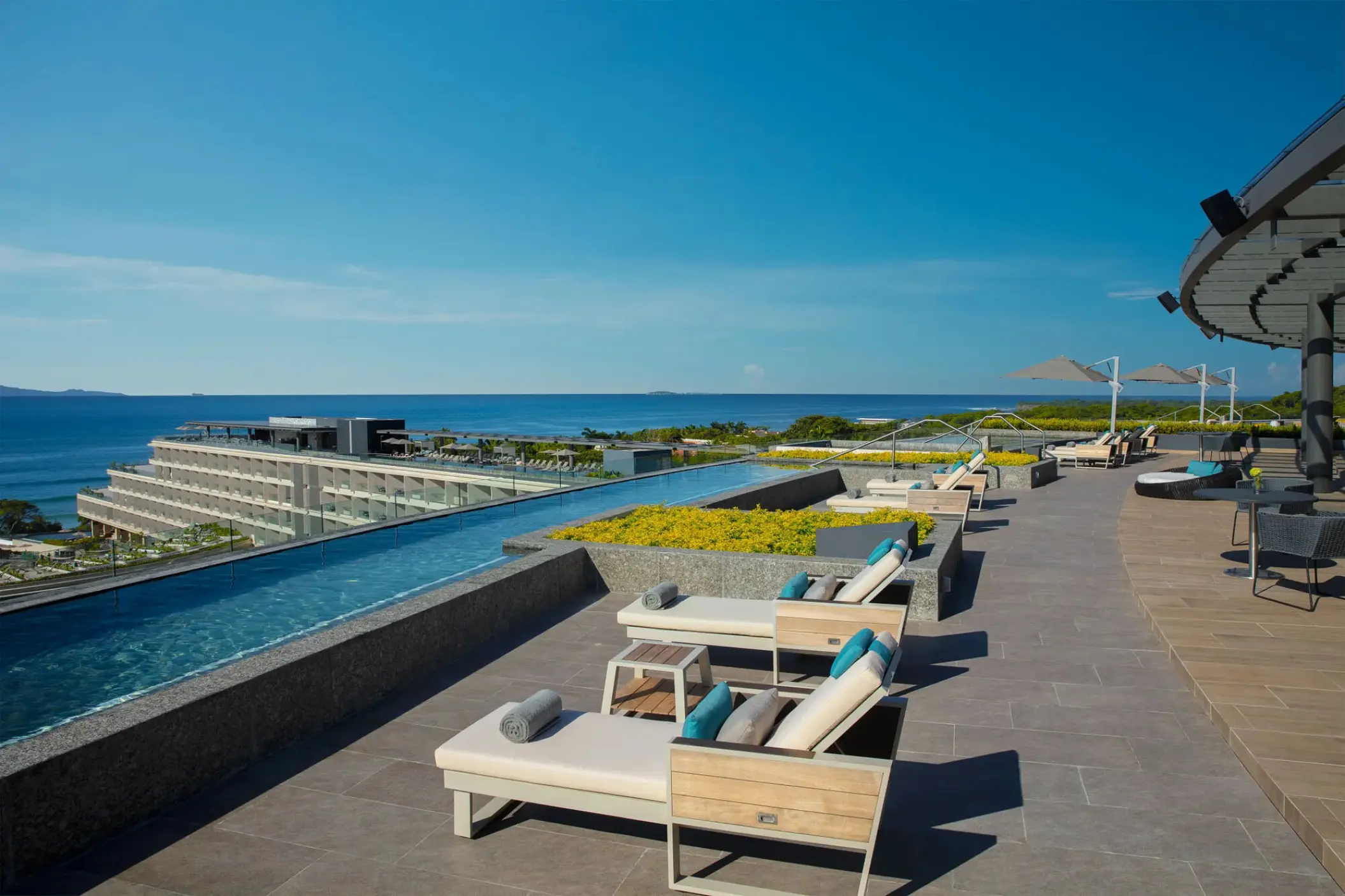 Secrets Bahia Mita rooftop infinity pool and sun loungers overlooking the ocean, Puerto Vallarta