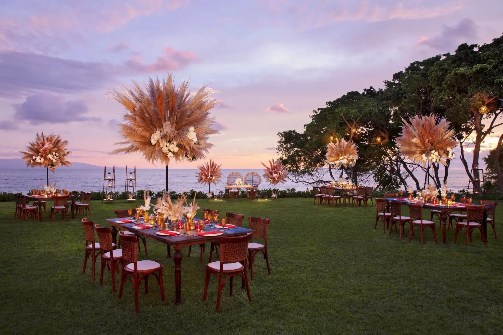 Outdoor wedding reception with pampas grass centerpieces at Secrets Bahia Mita, Puerto Vallarta