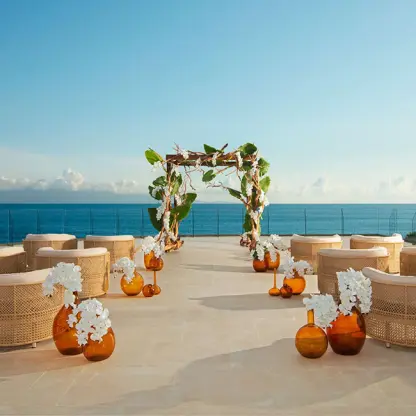 Rooftop wedding ceremony with tropical floral arch and ocean views at Secrets Bahia Mita, Puerto Vallarta