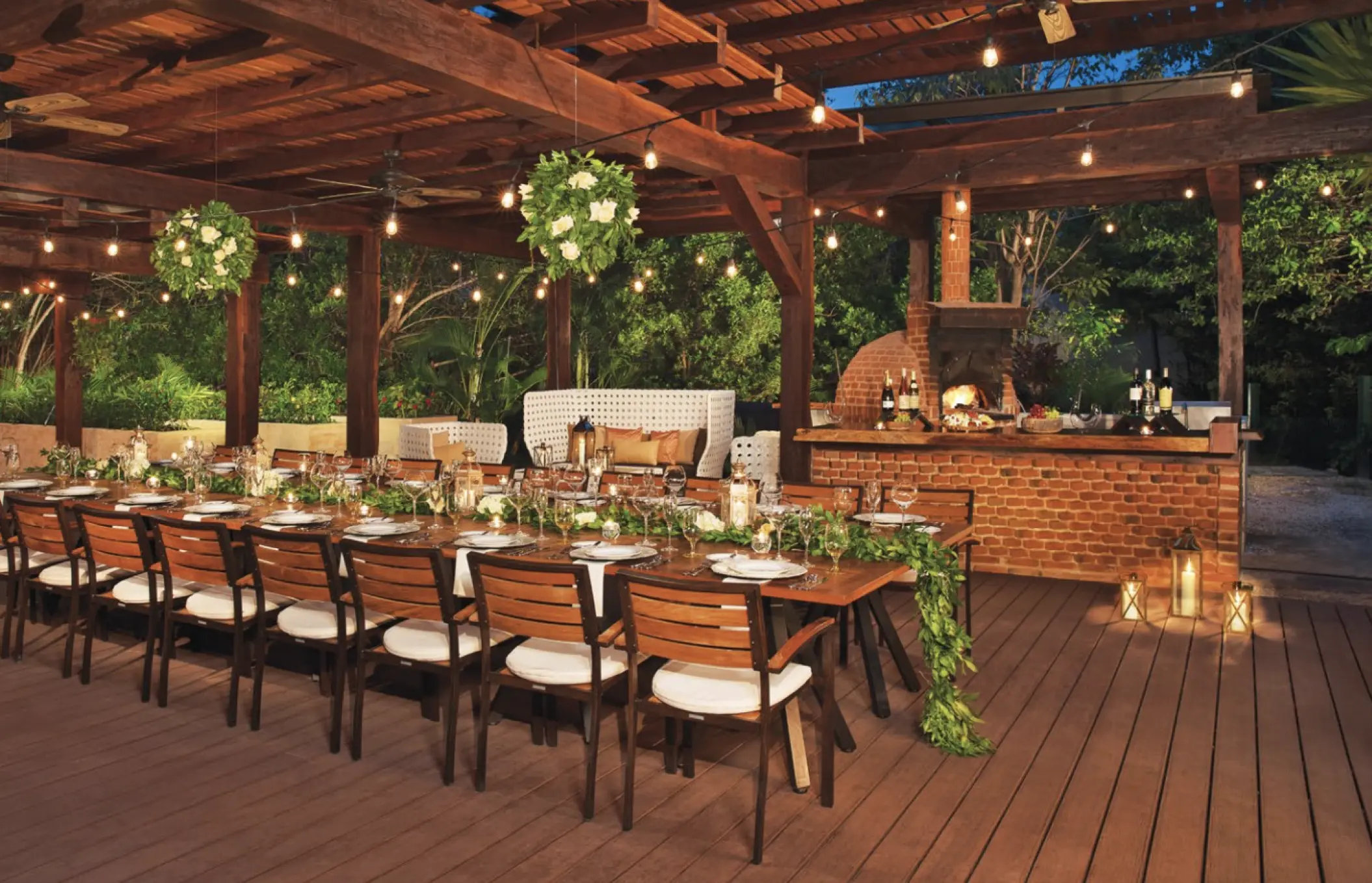 Long wooden table reception under a rustic pergola at Dreams Aventuras, Riviera Maya