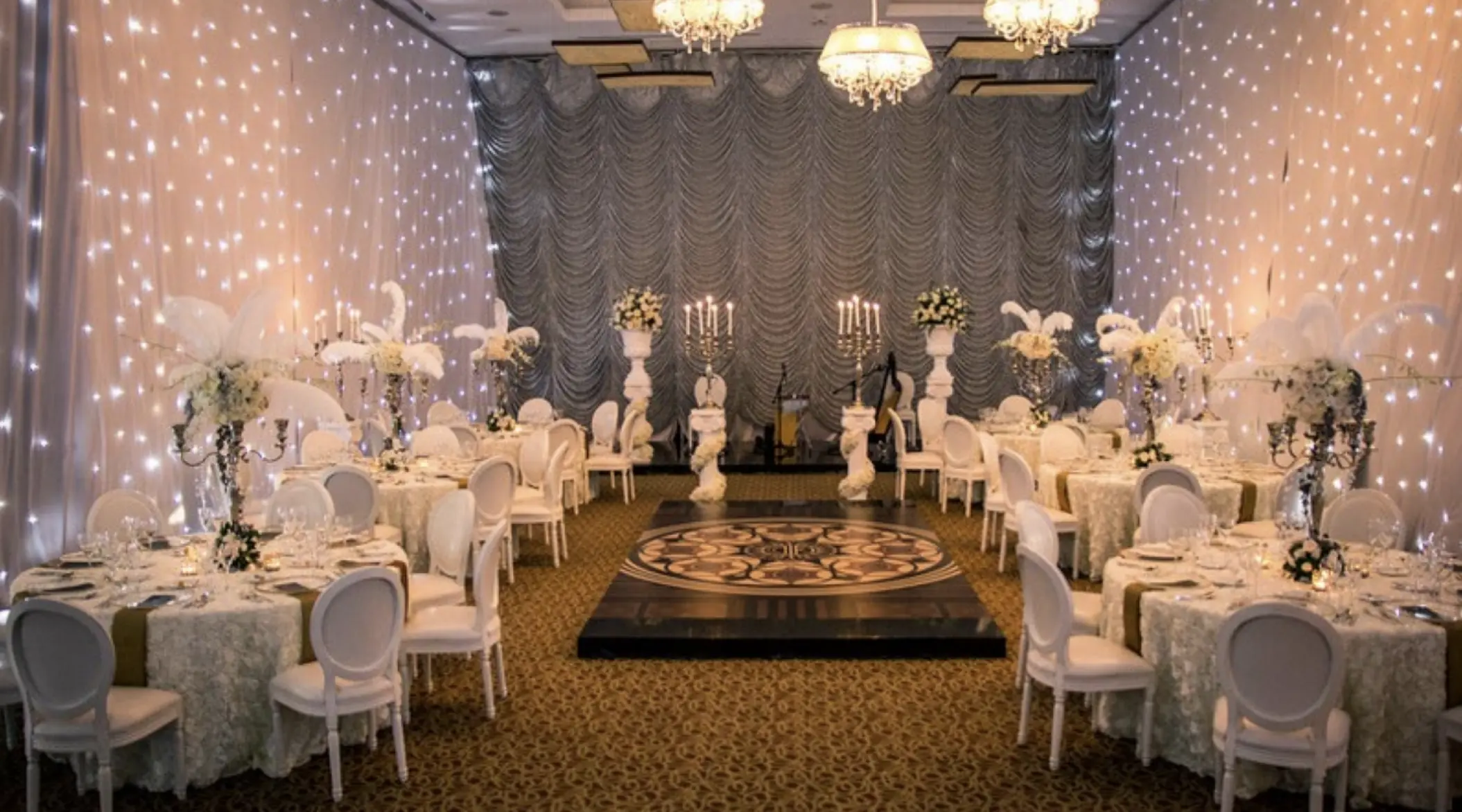 Indoor ballroom wedding reception with fairy light walls and dance floor at Dreams Aventuras, Riviera Maya