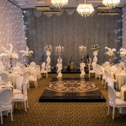 Indoor wedding reception ballroom with string lights and white centerpieces at Dreams Aventuras, Riviera Maya