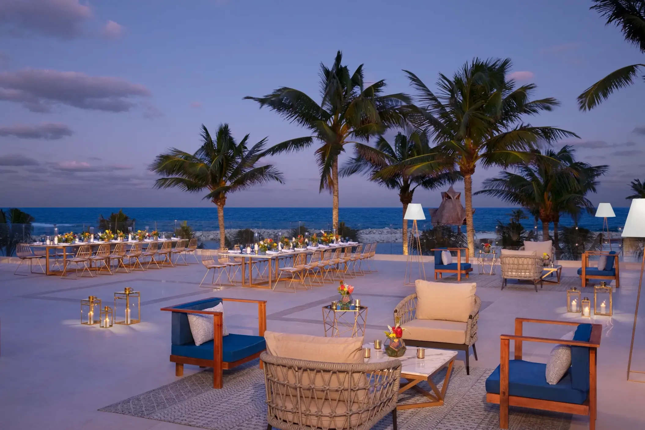 Rooftop wedding reception with lounge seating and palm trees at Dreams Aventuras, Riviera Maya