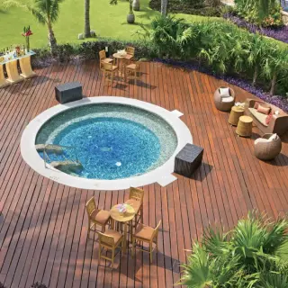 Dreams Aventuras circular whirlpool and wooden deck with outdoor lounge seating, Riviera Maya