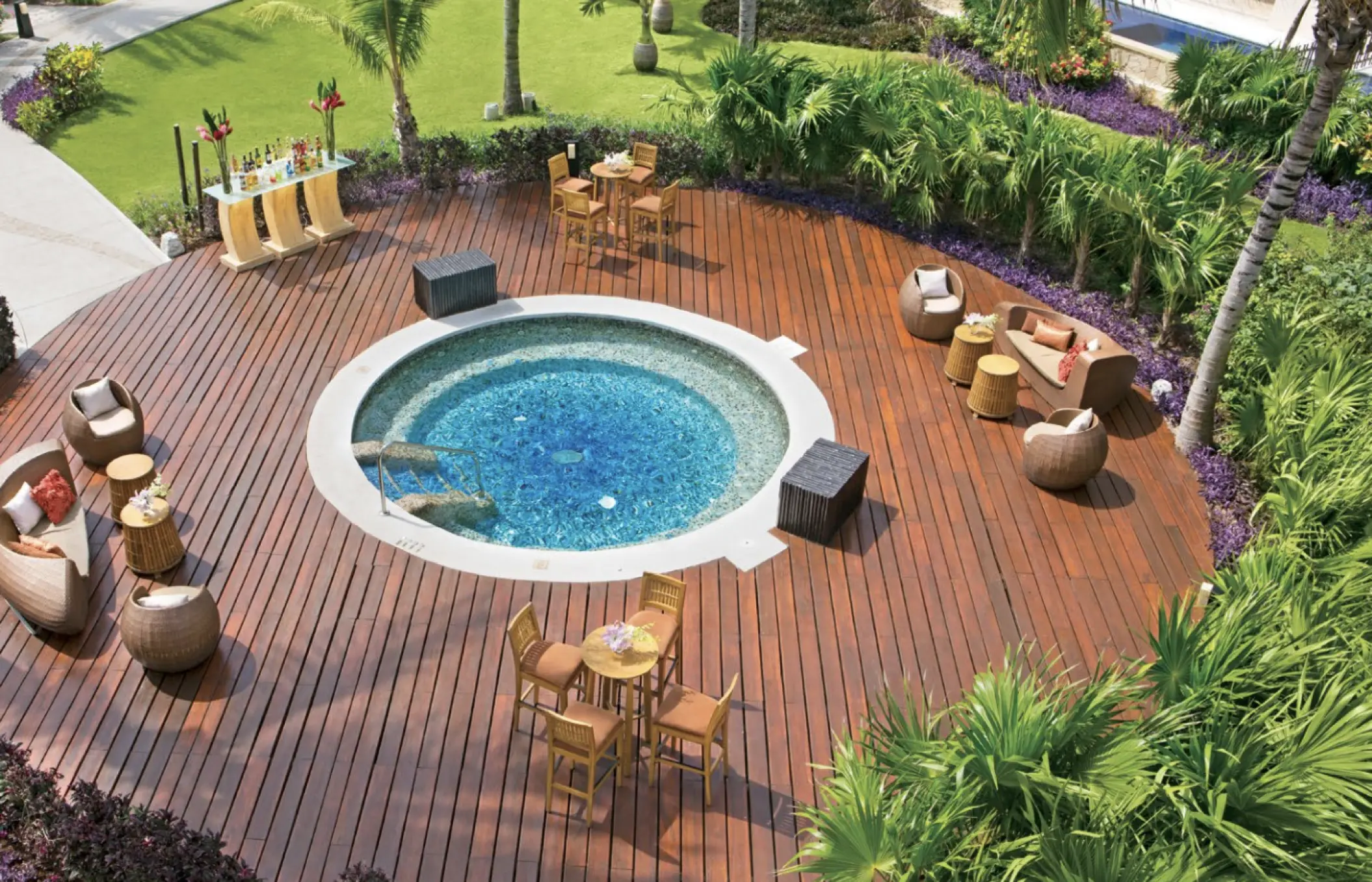 Dreams Aventuras circular whirlpool and wooden deck with outdoor lounge seating, Riviera Maya