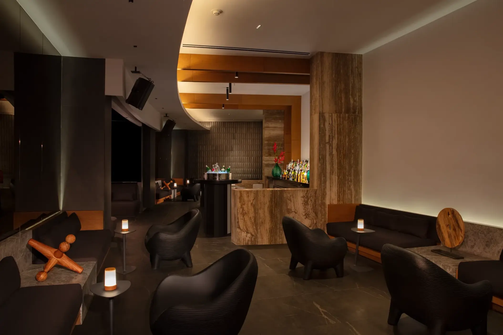 Modern cocktail bar with sculptural seating and marble accents at Dreams Bahia Mita, Puerto Vallarta