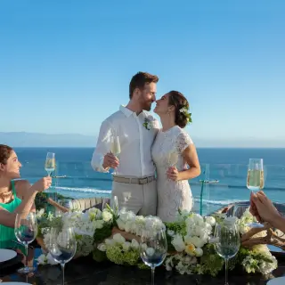 Bride and groom toasting with guests during a wedding reception at Dreams Bahia Mita, Puerto Vallarta