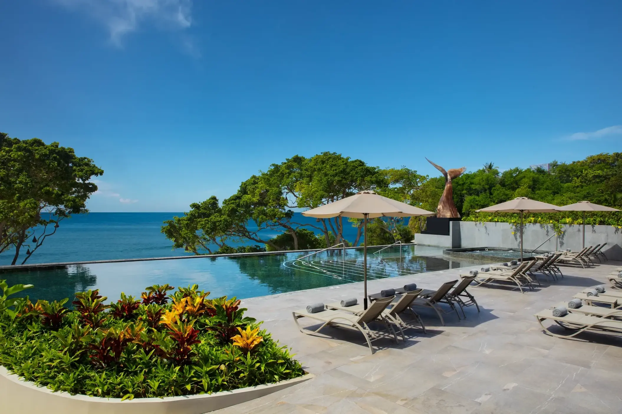 Dreams Bahia Mita infinity pool and sun loungers overlooking the ocean