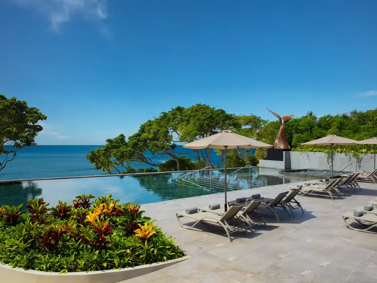 Dreams Bahia Mita infinity pool and sun loungers overlooking the ocean