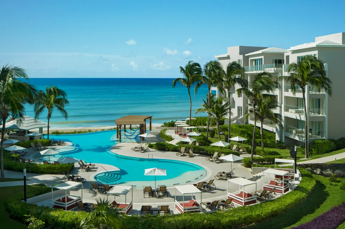 Dreams Jade adult pool area and sun loungers overlooking the Caribbean Sea, Riviera Maya