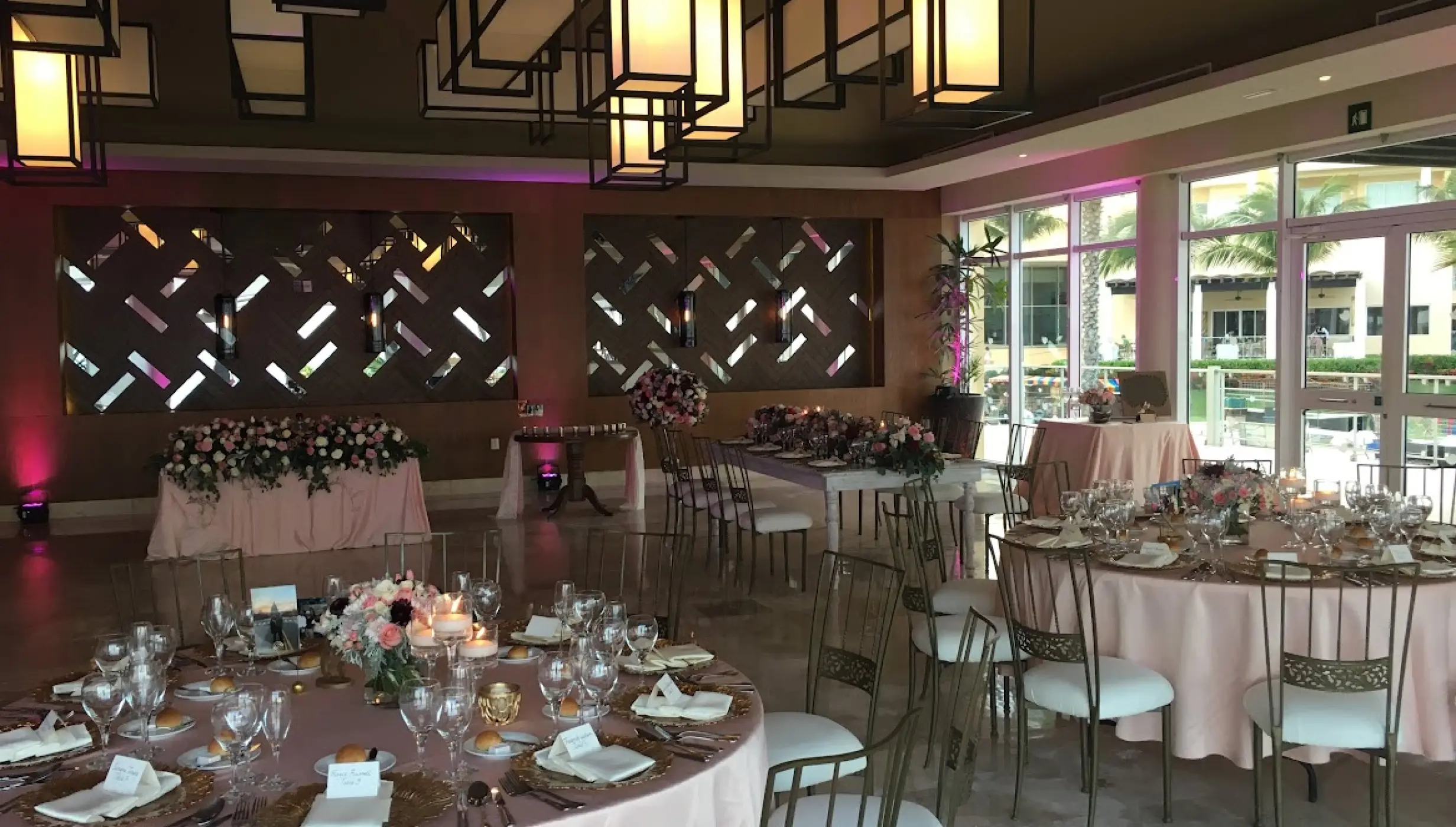 Indoor wedding reception with round tables and pink linens at Dreams Jade, Riviera Maya