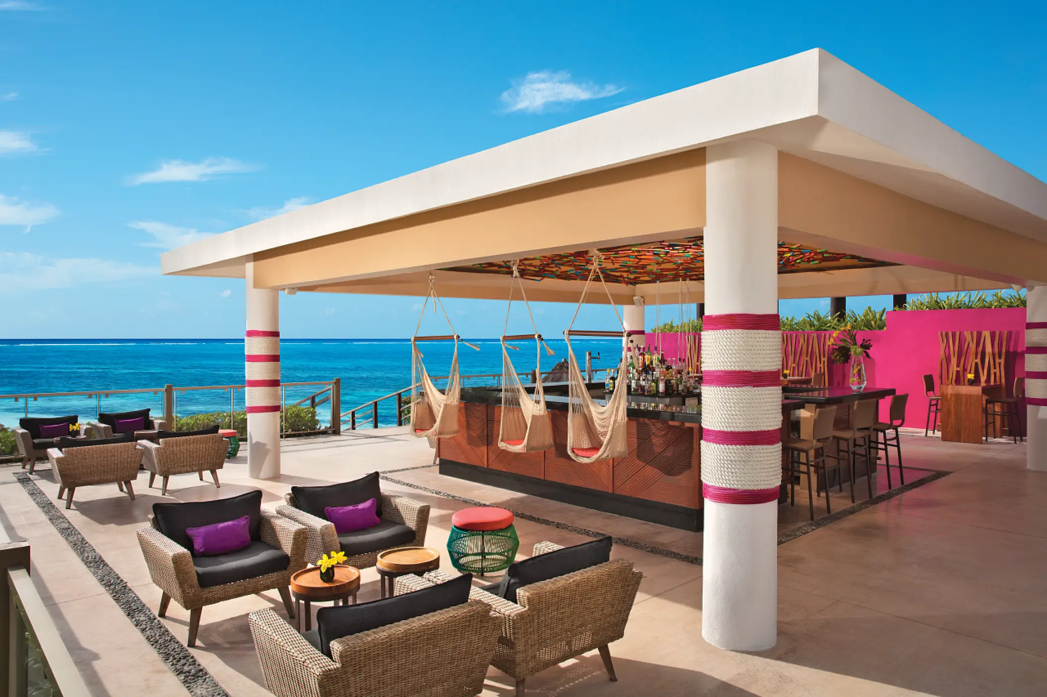 Open-air bar with hammock seating and ocean views at Dreams Jade, Riviera Maya