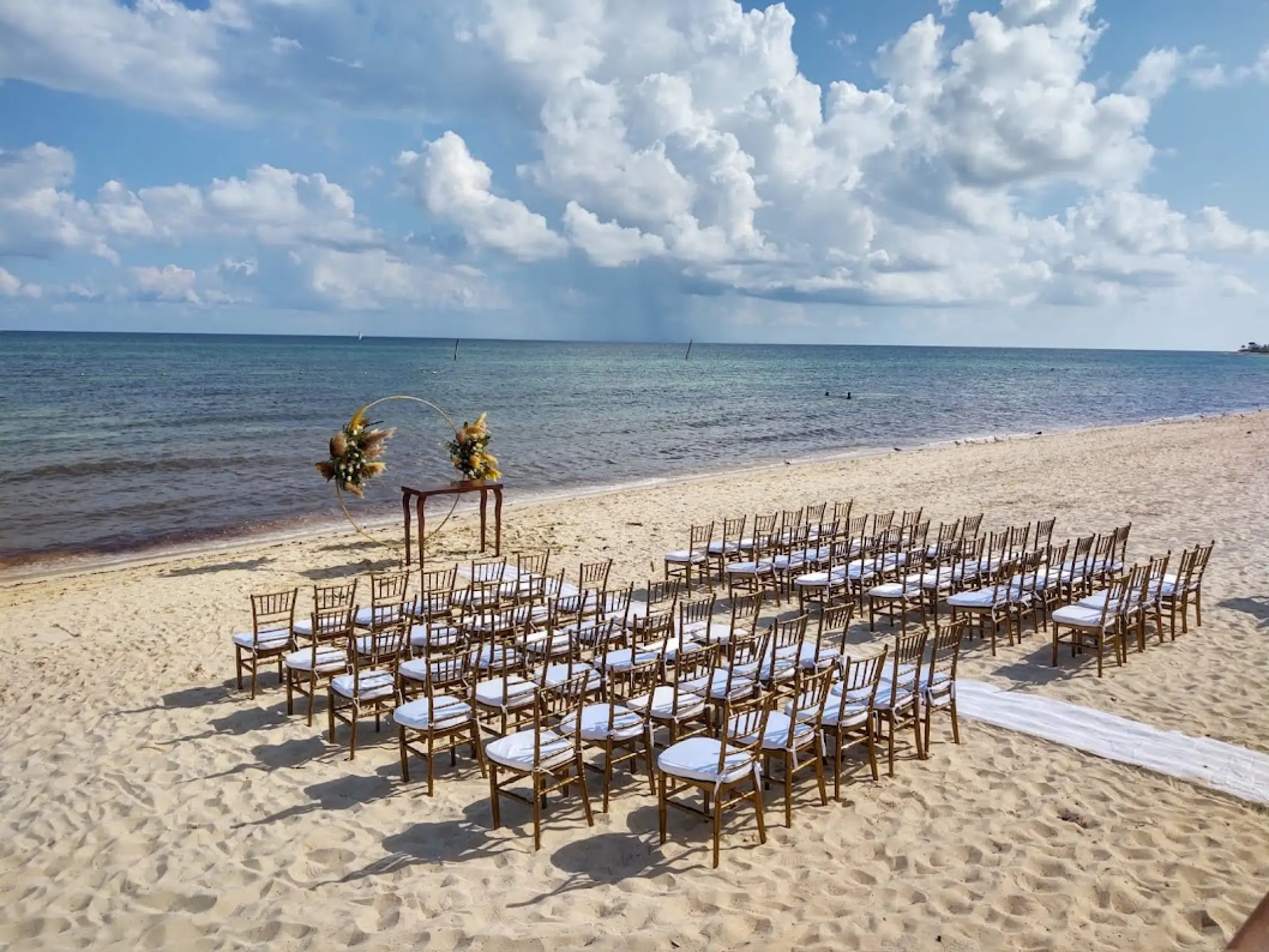 Beachfront wedding ceremony with rows of chairs at Dreams Jade, Riviera Maya